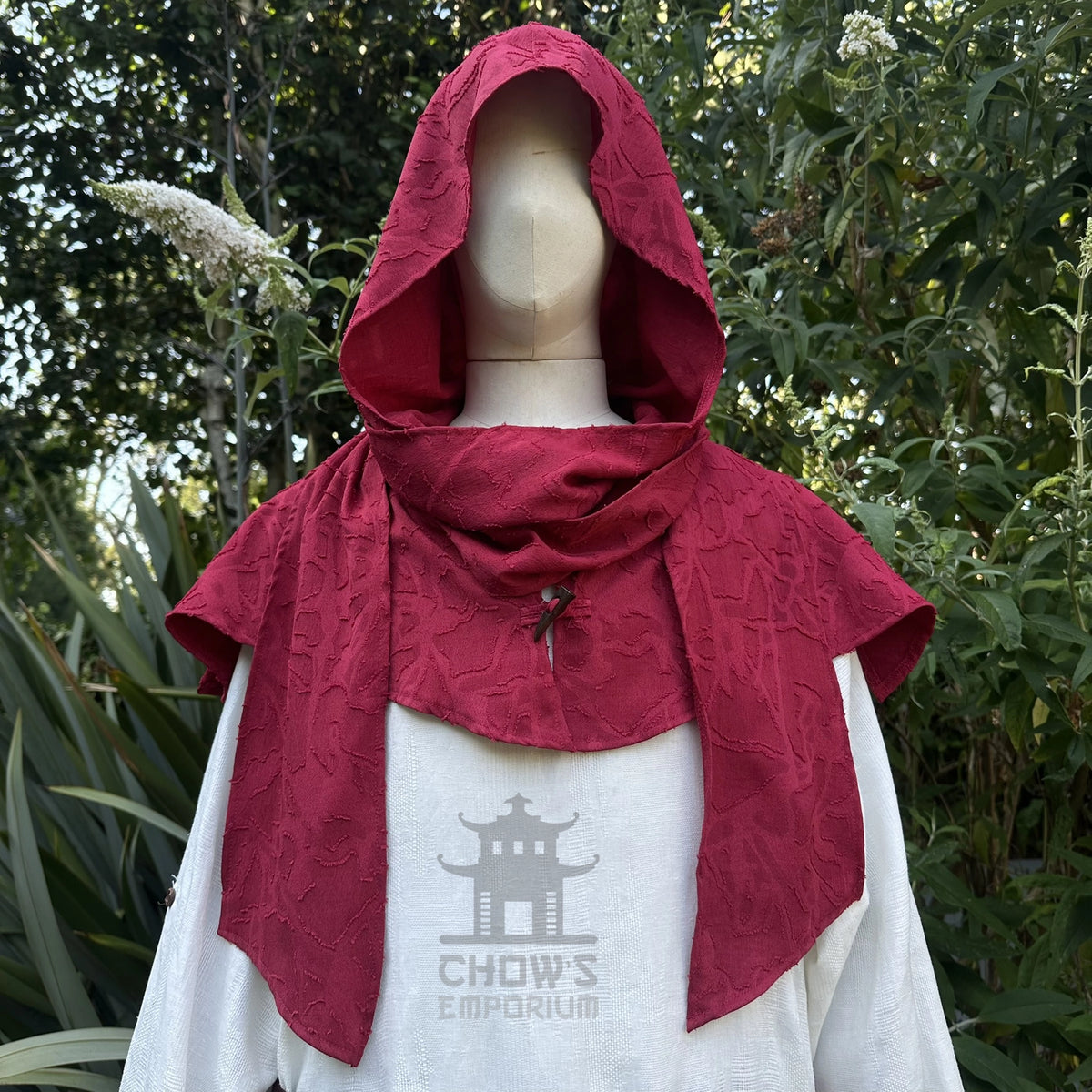 Red medieval scarf hood worn up over the head, wraparound ends draped
