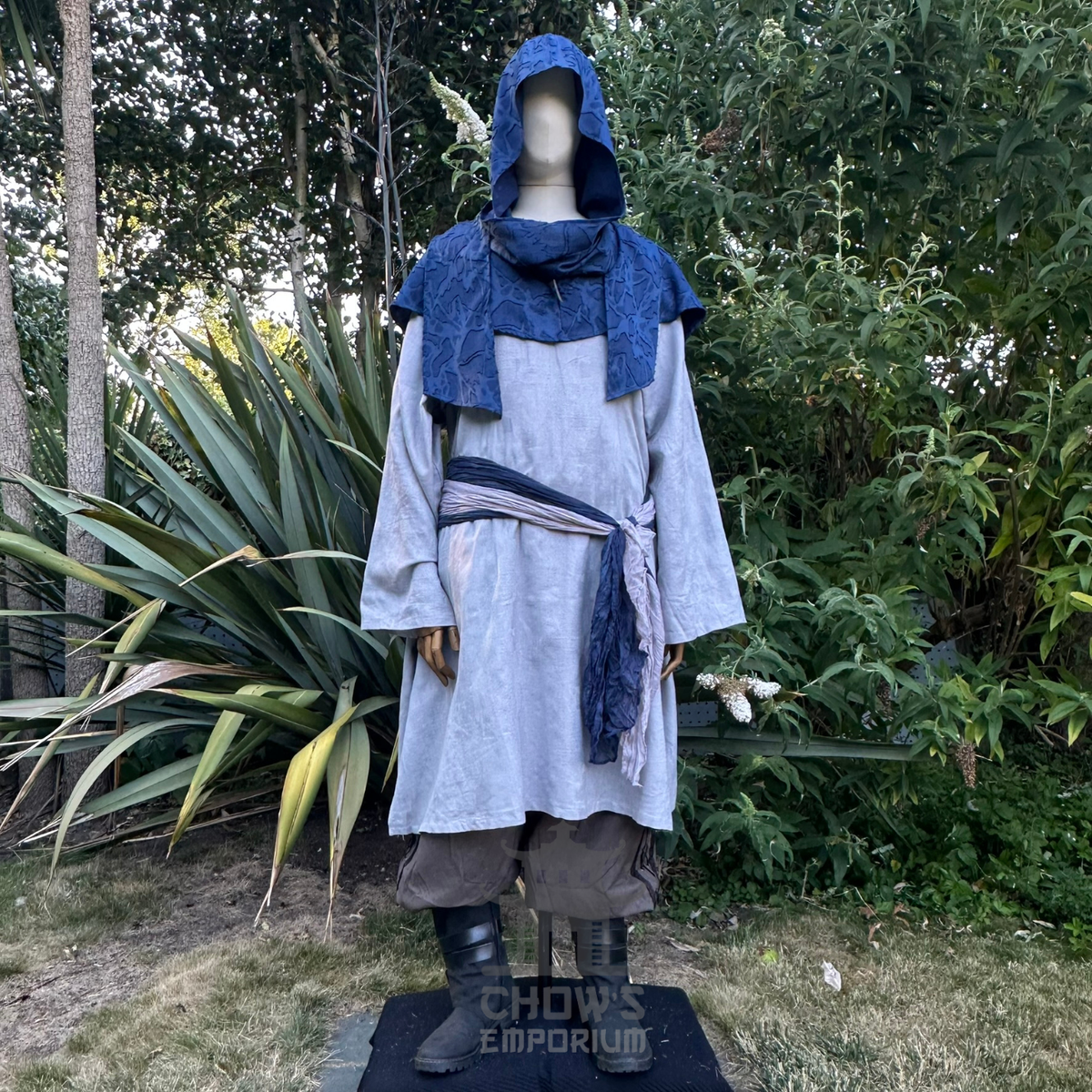 Blue scarf hood worn as a cowl round the shoulders over a white shirt