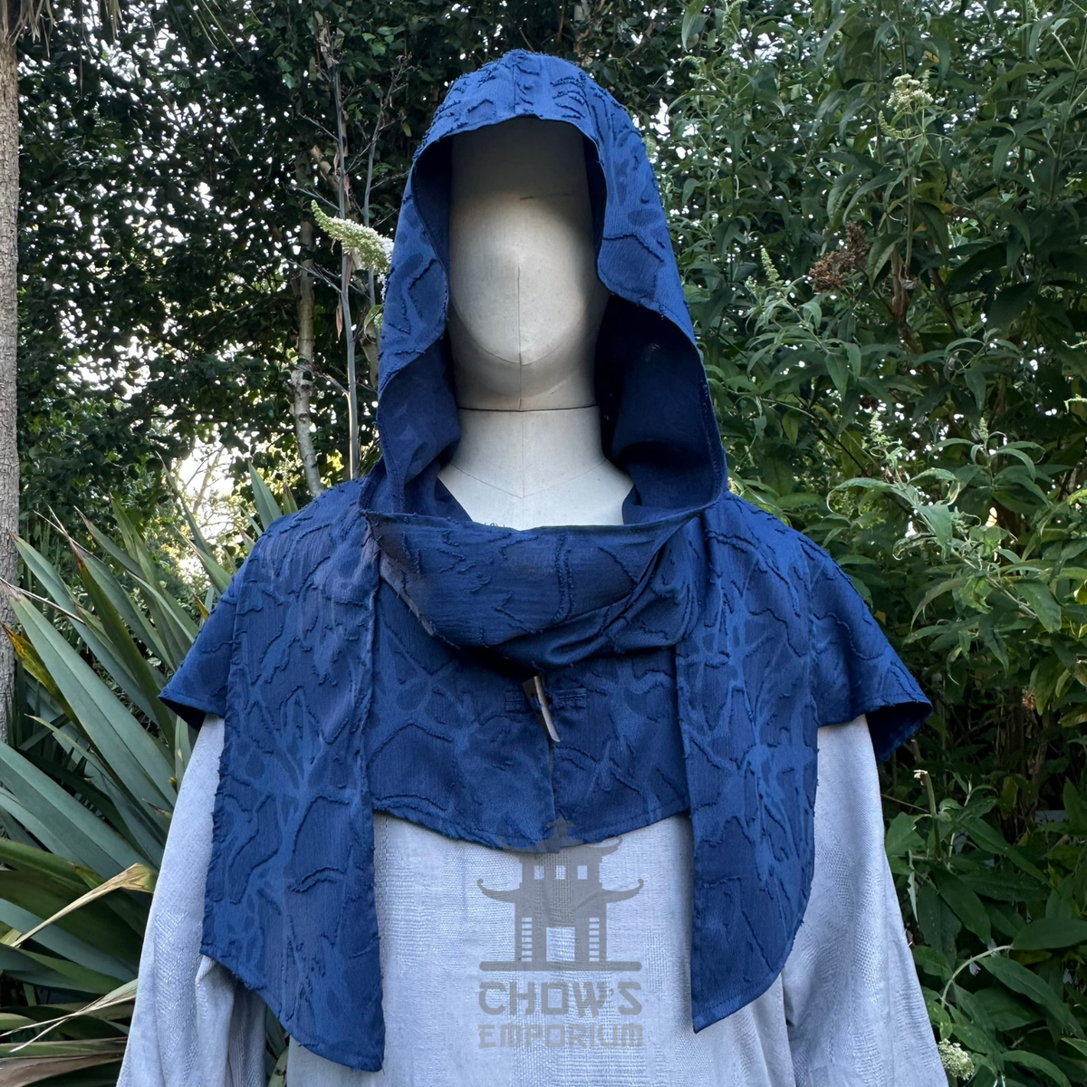 Blue medieval scarf hood worn up over the head, wraparound ends draped
