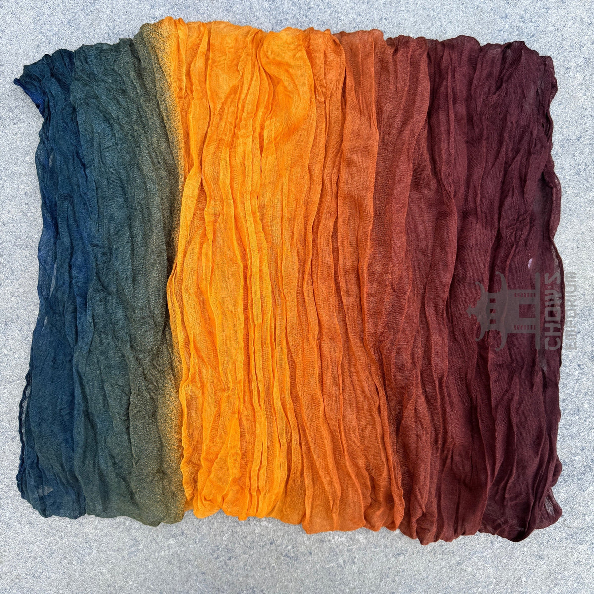 Folded Spice pirate sash showing warm autumn gradient with teal band