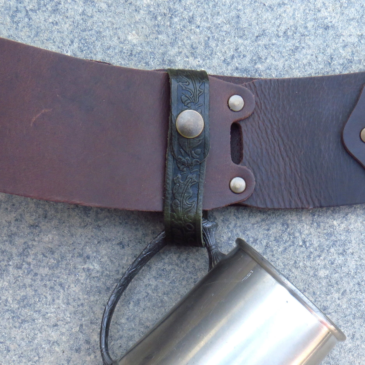 Close view of the leather tankard loop fastened around a belt