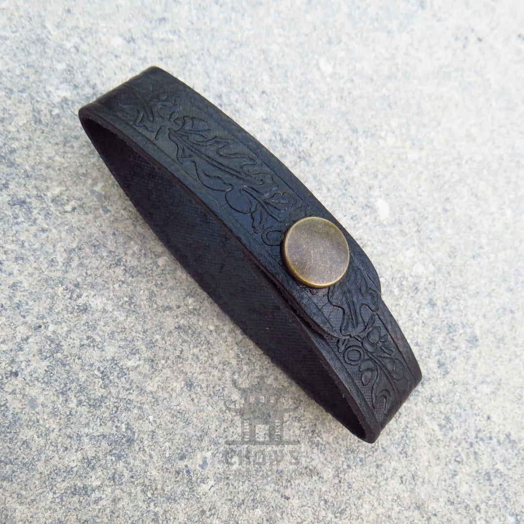 Dark brown leather tankard loop showing the running oak leaf pattern