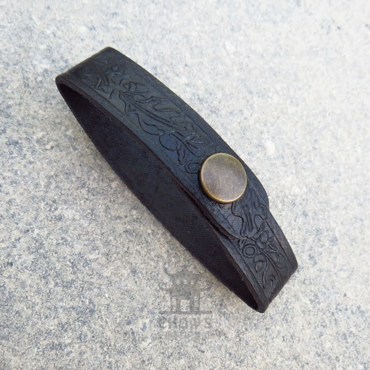 Dark brown leather tankard loop showing the running oak leaf pattern