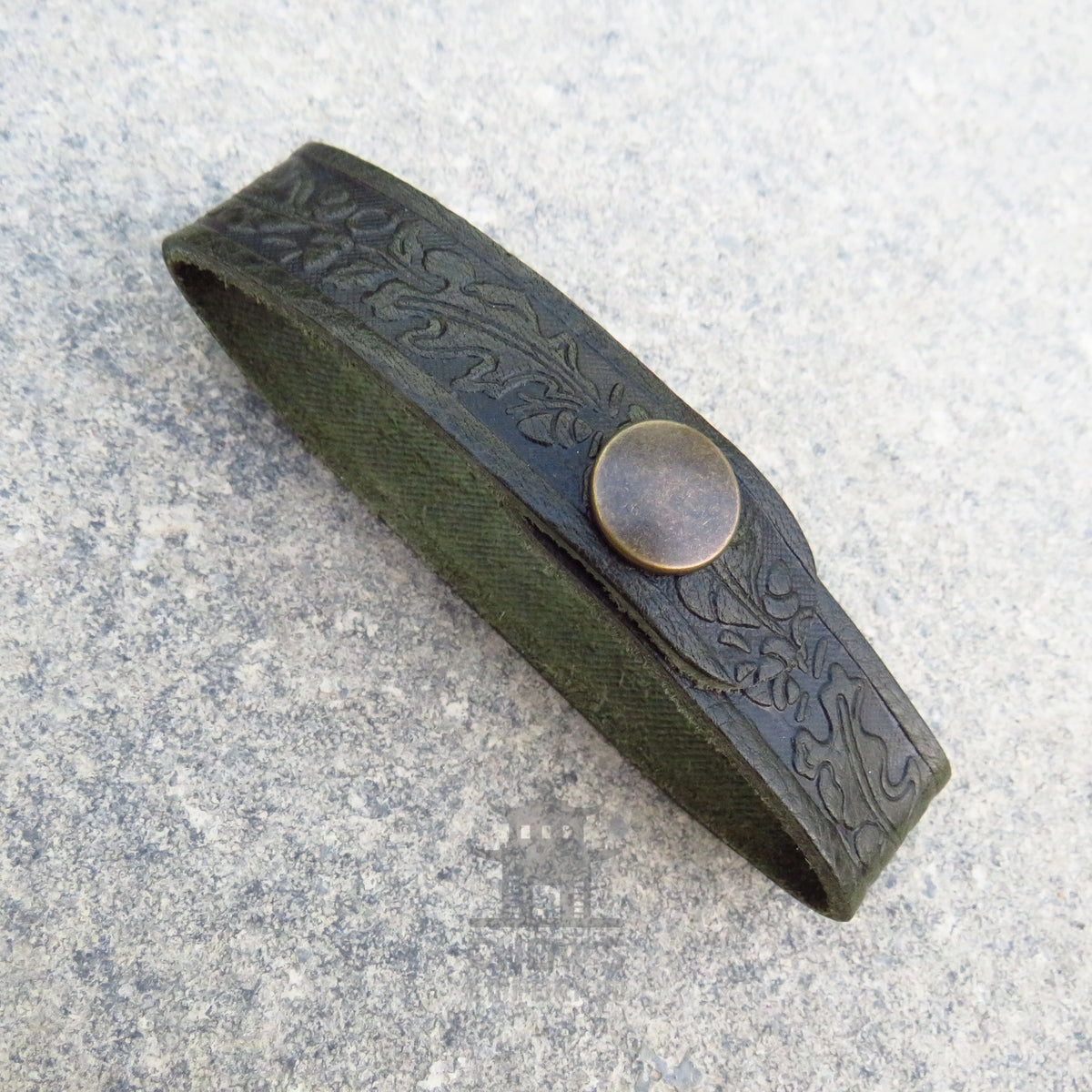 Dark green leather tankard loop showing the oak leaf embossing