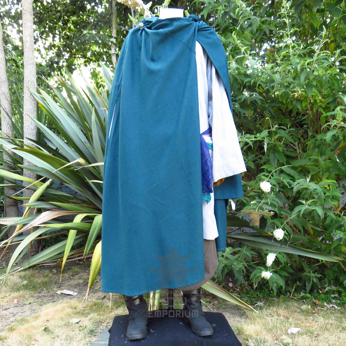 Teal cloak swept back over one shoulder showing the costume underneath, other pieces sold separately
