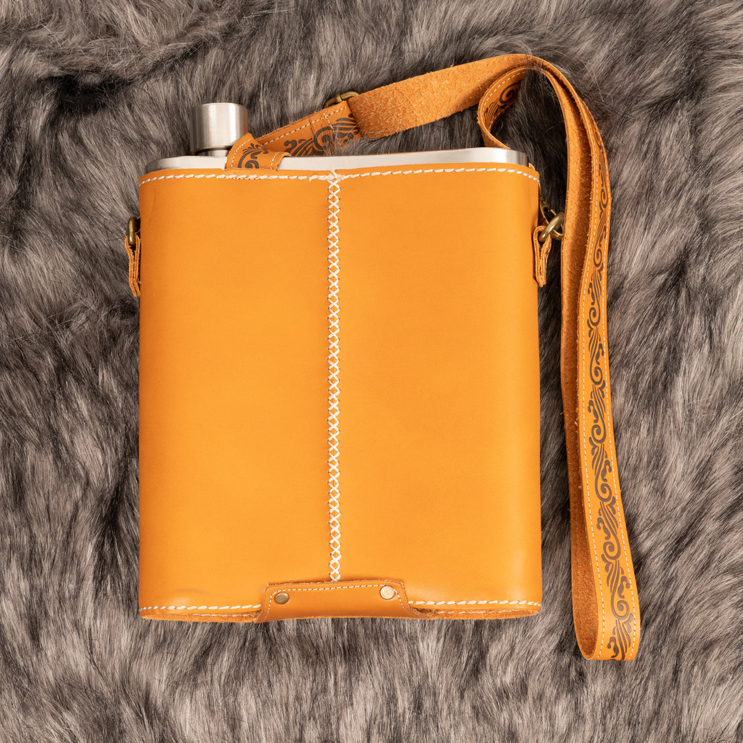 Medieval LARP flask with leather case and strap on fur backdrop.