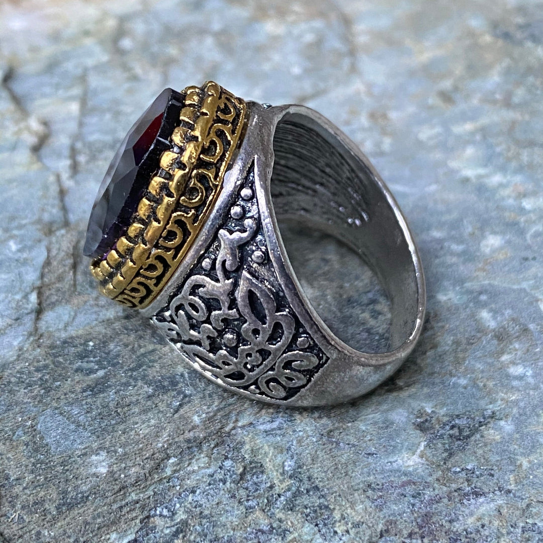 Ornate side view of deep purple gem ring, silver and gold for medieval LARP.