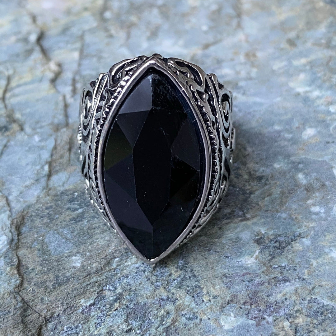 Ornate black gemstone ring on stone for LARP.