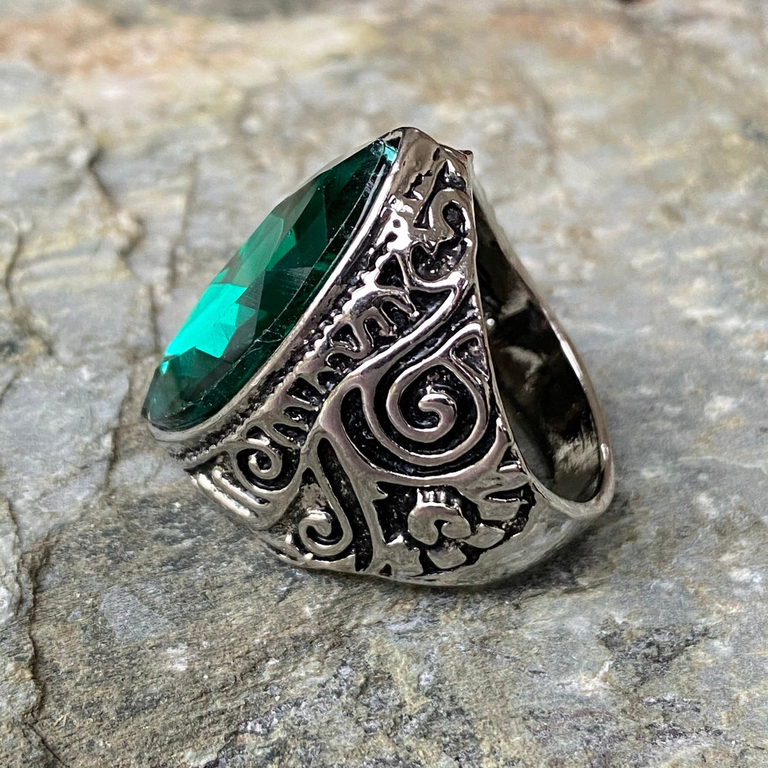 Ornate medieval ring with green gem, side view for LARP adventures.