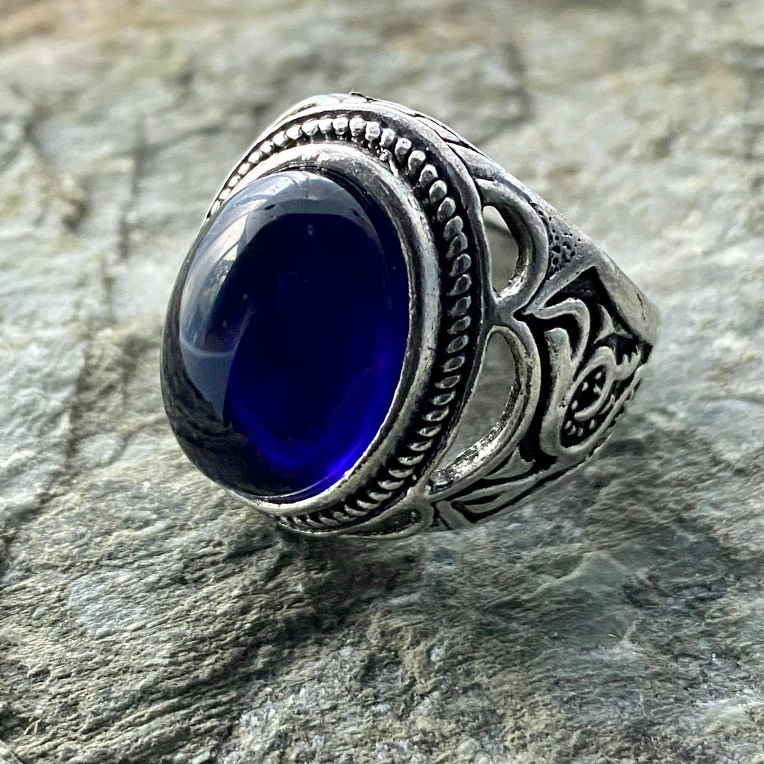 Silver filigree ring with deep blue gem, side view for LARP.