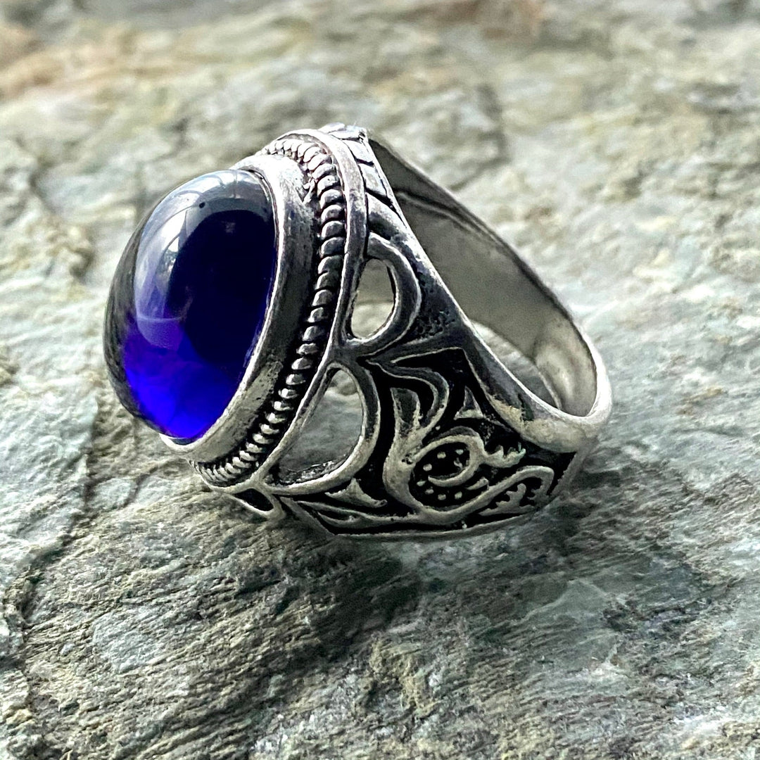 Silver ring with ornate filigree and blue gemstone, medieval LARP style.