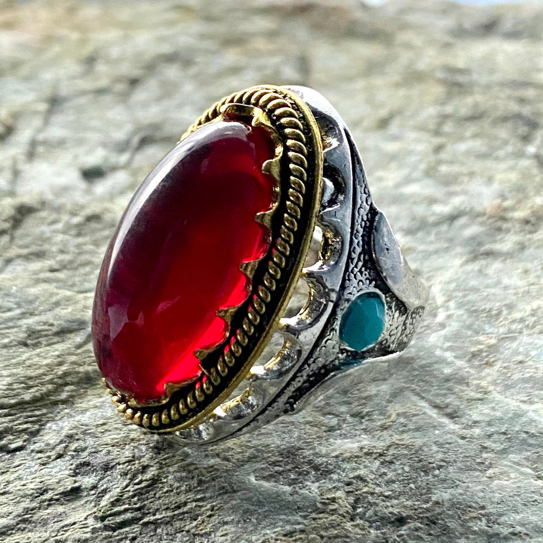 Red gemstone ring with intricate silver-gold design for medieval LARP.
