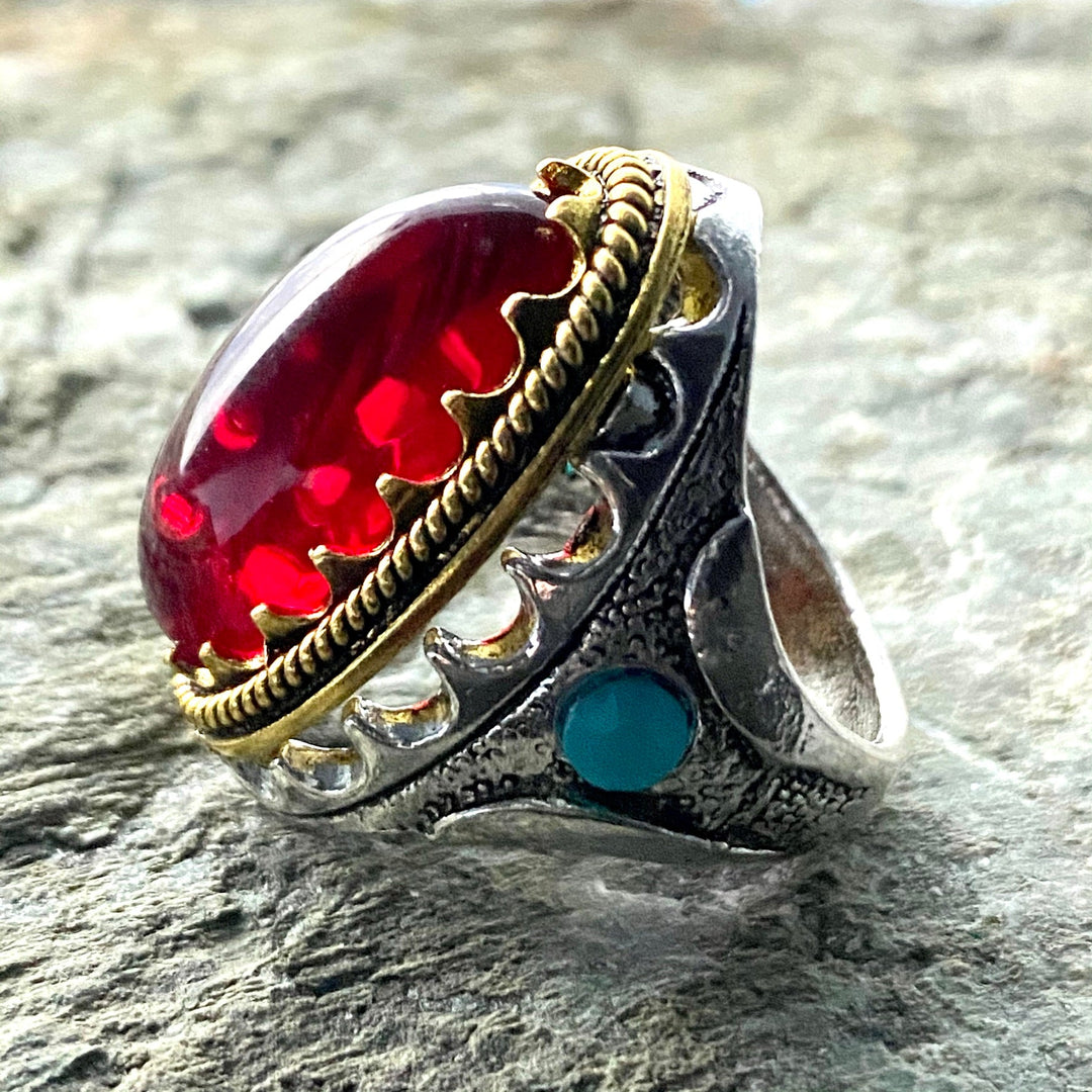 Silver and gold ring with red gem, side view, medieval LARP accessory.
