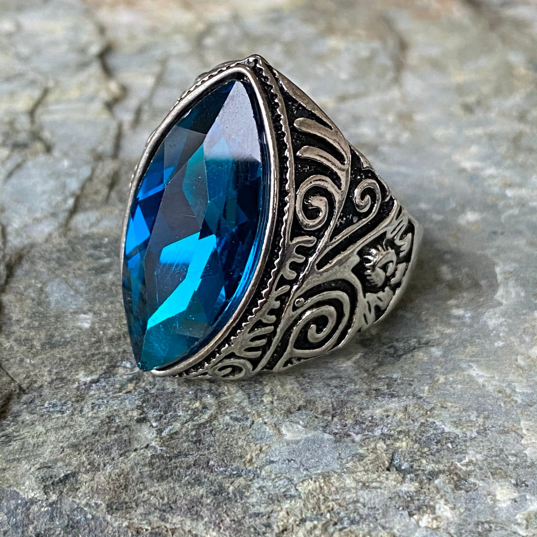 Intricate medieval LARP ring with turquoise gem, side view engraving.