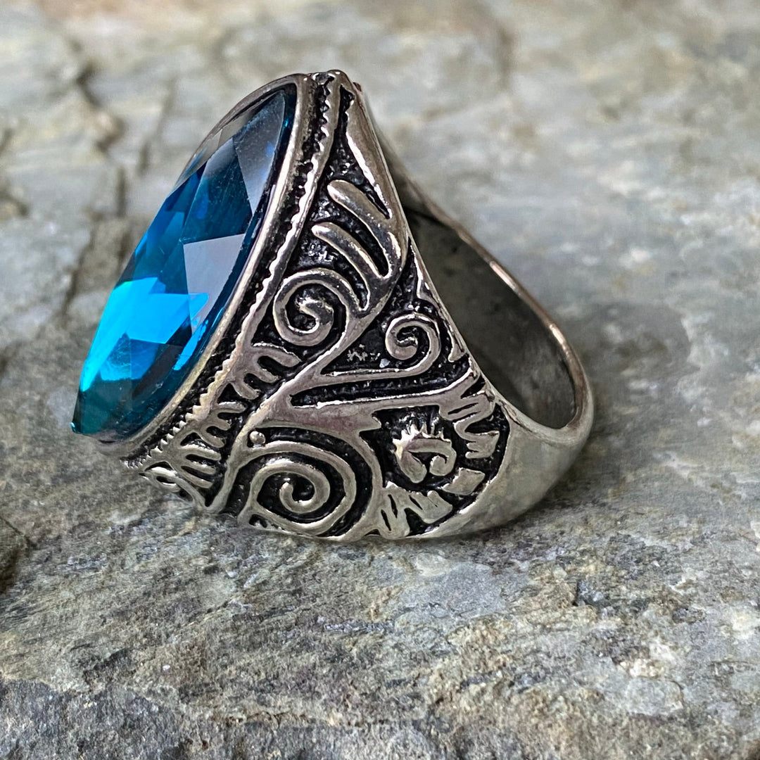 Ornate turquoise ring with intricate medieval swirl design for LARP.