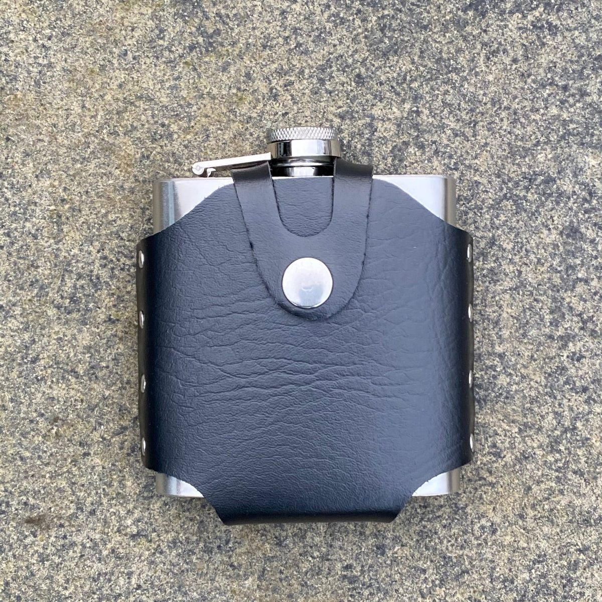 Black hip flask leather holder on stone for LARP.