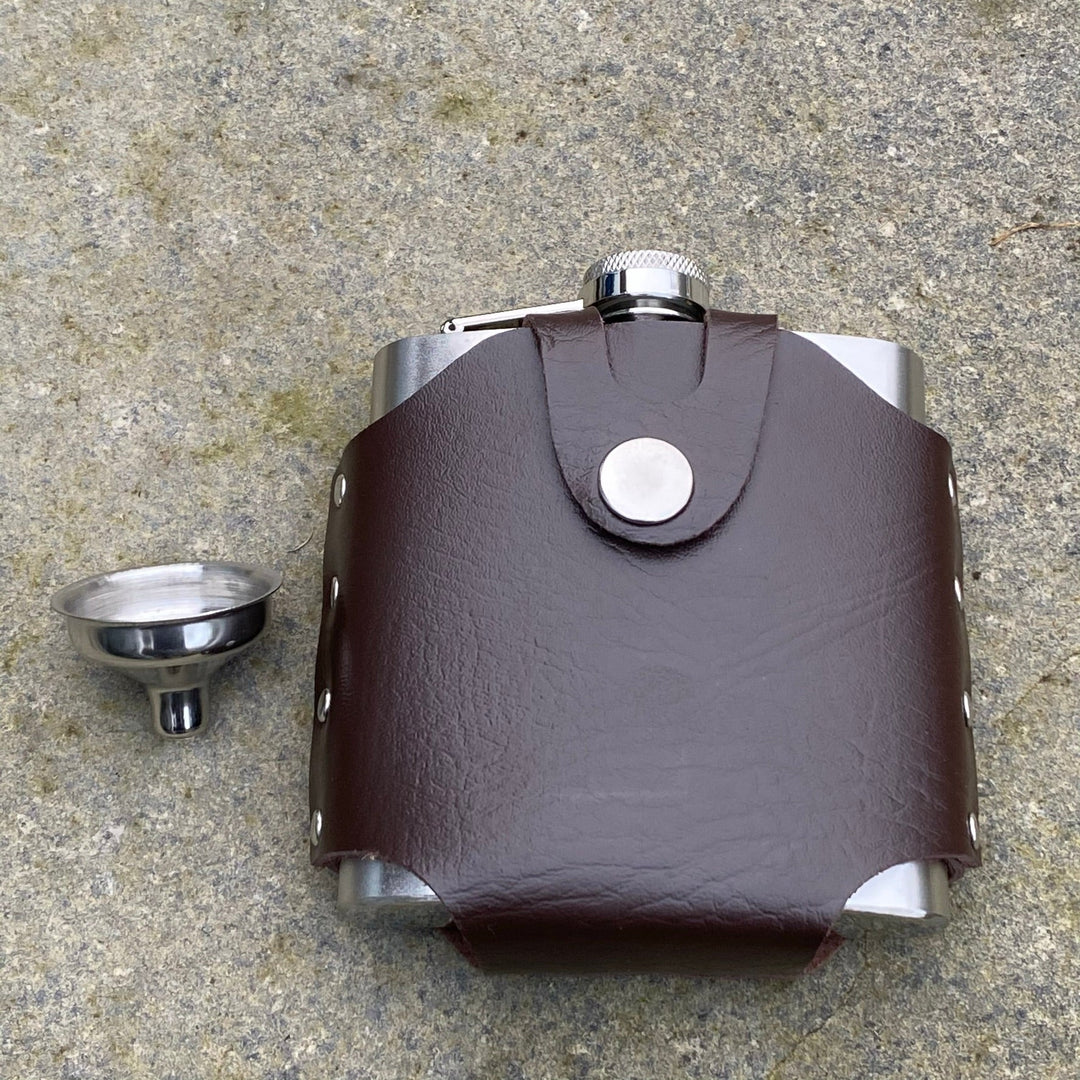 Brown leather hip flask with belt holder on stone, medieval LARP style.