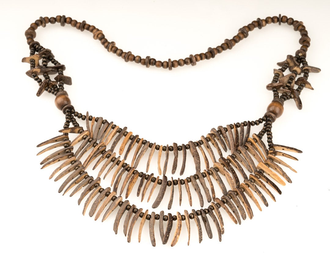 Brown tooth necklace with intricate beadwork, medieval LARP accessory.