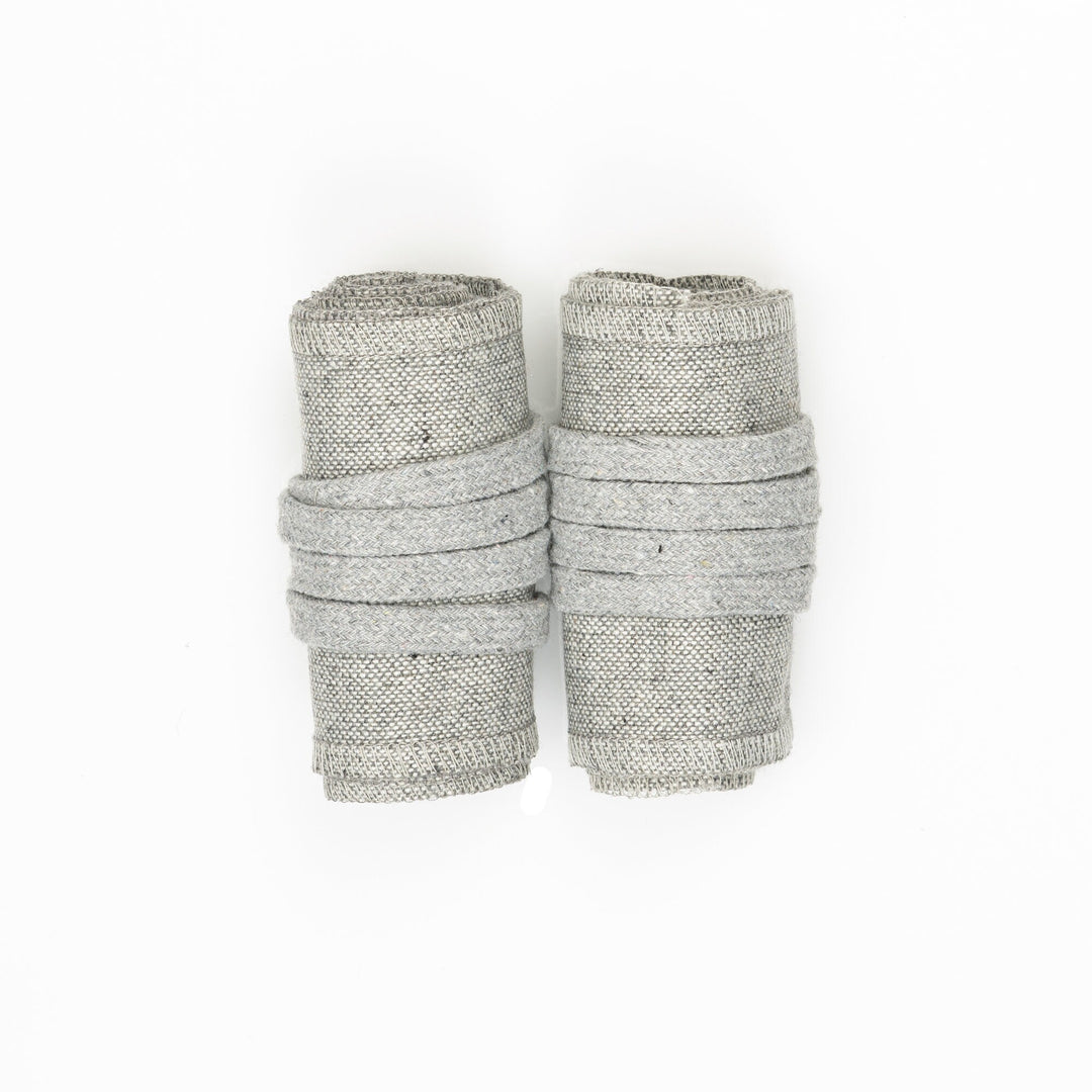 Light grey wool arm wraps rolled, top view for LARP or medieval attire.