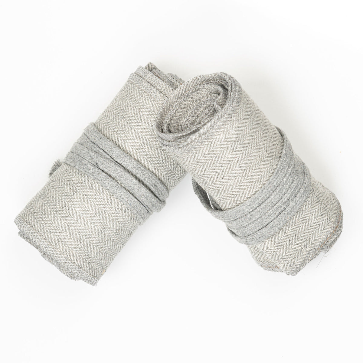 Grey herringbone wool leg wraps, rolled, top view for LARP.