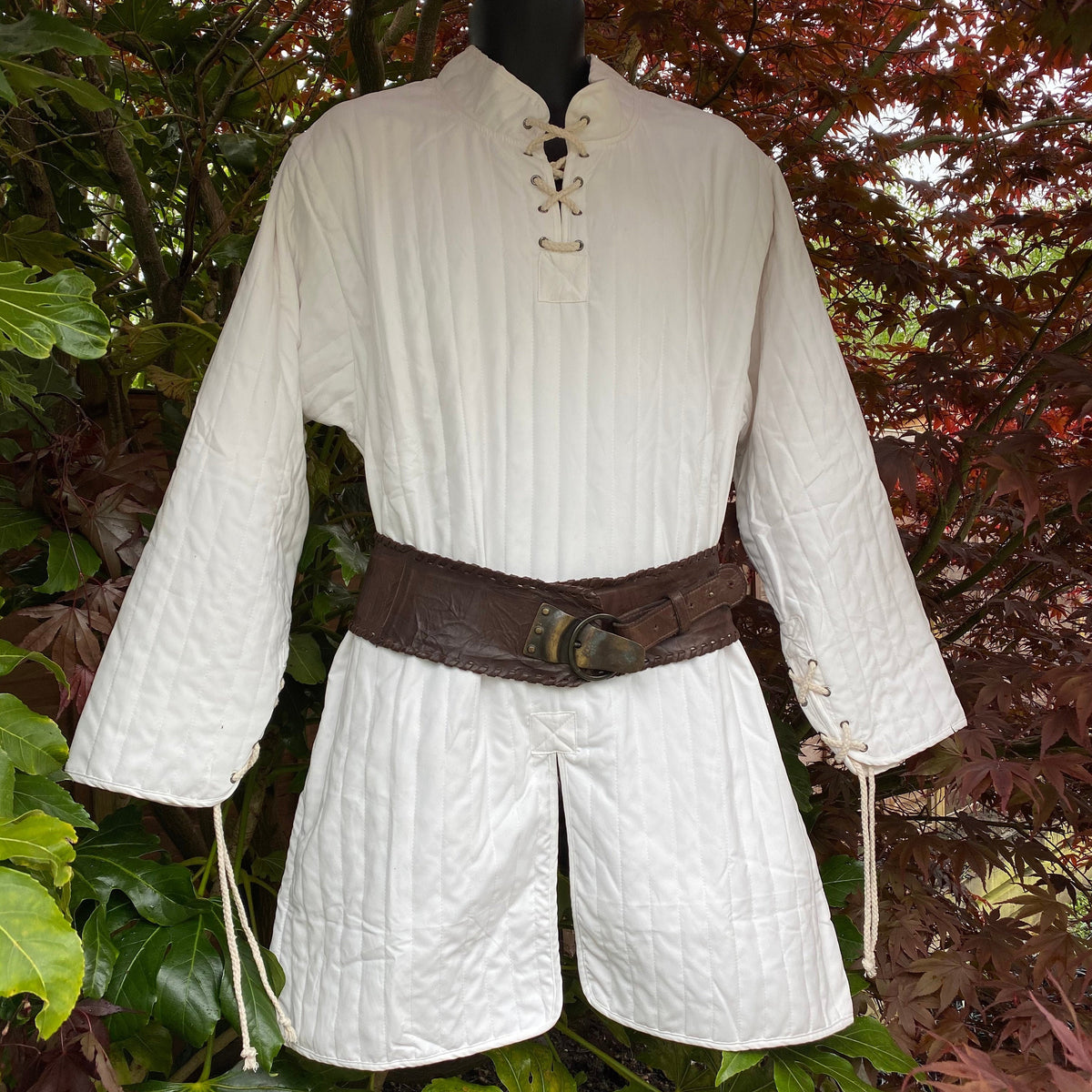 dark red quilted gambeson styled for medieval events.