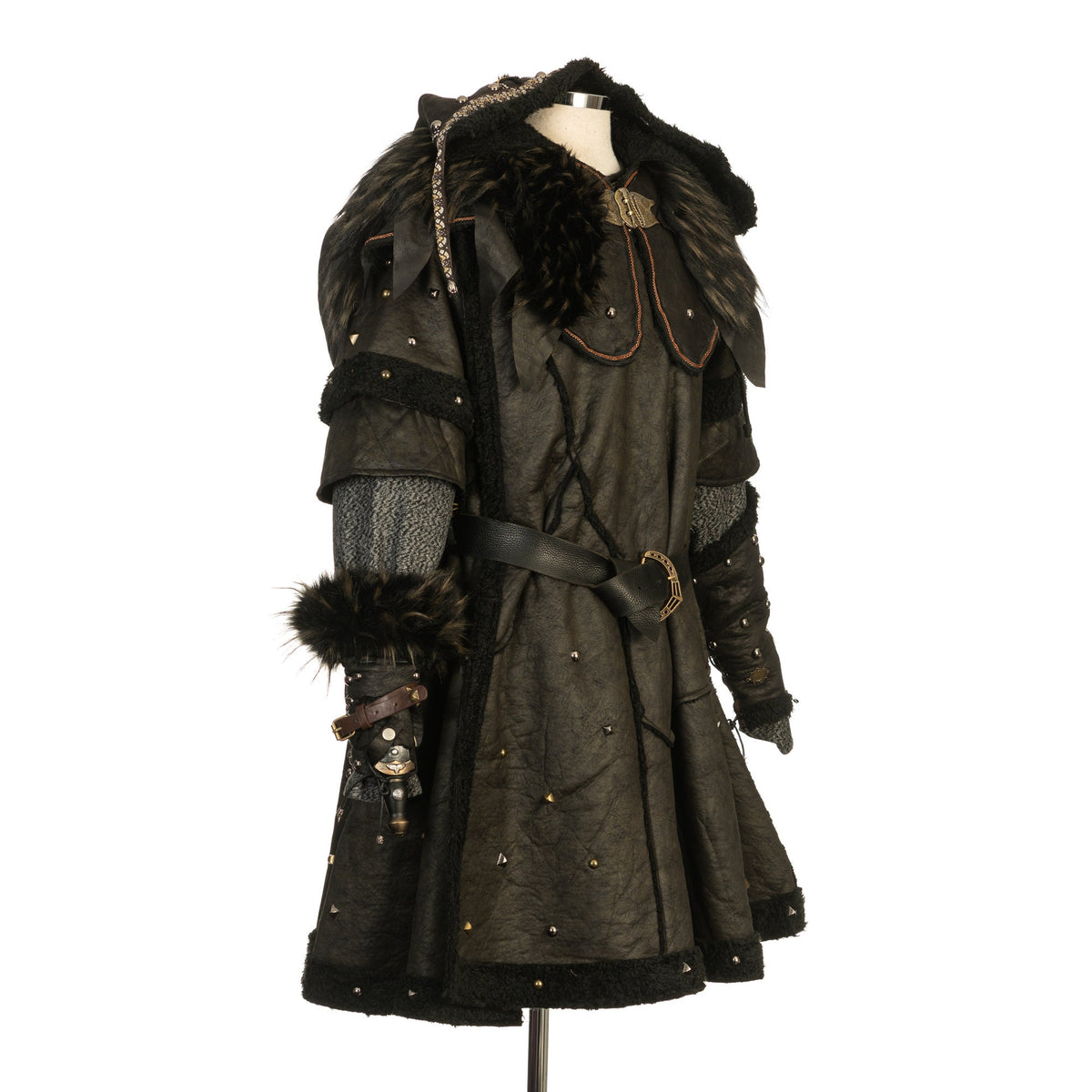 Medieval LARP costume side view featuring a black faux leather tunic, hood and vambraces.