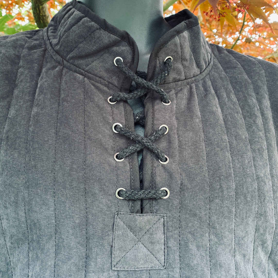 Close-up of black cotton gambeson with crisscross lacing for LARP or medieval.