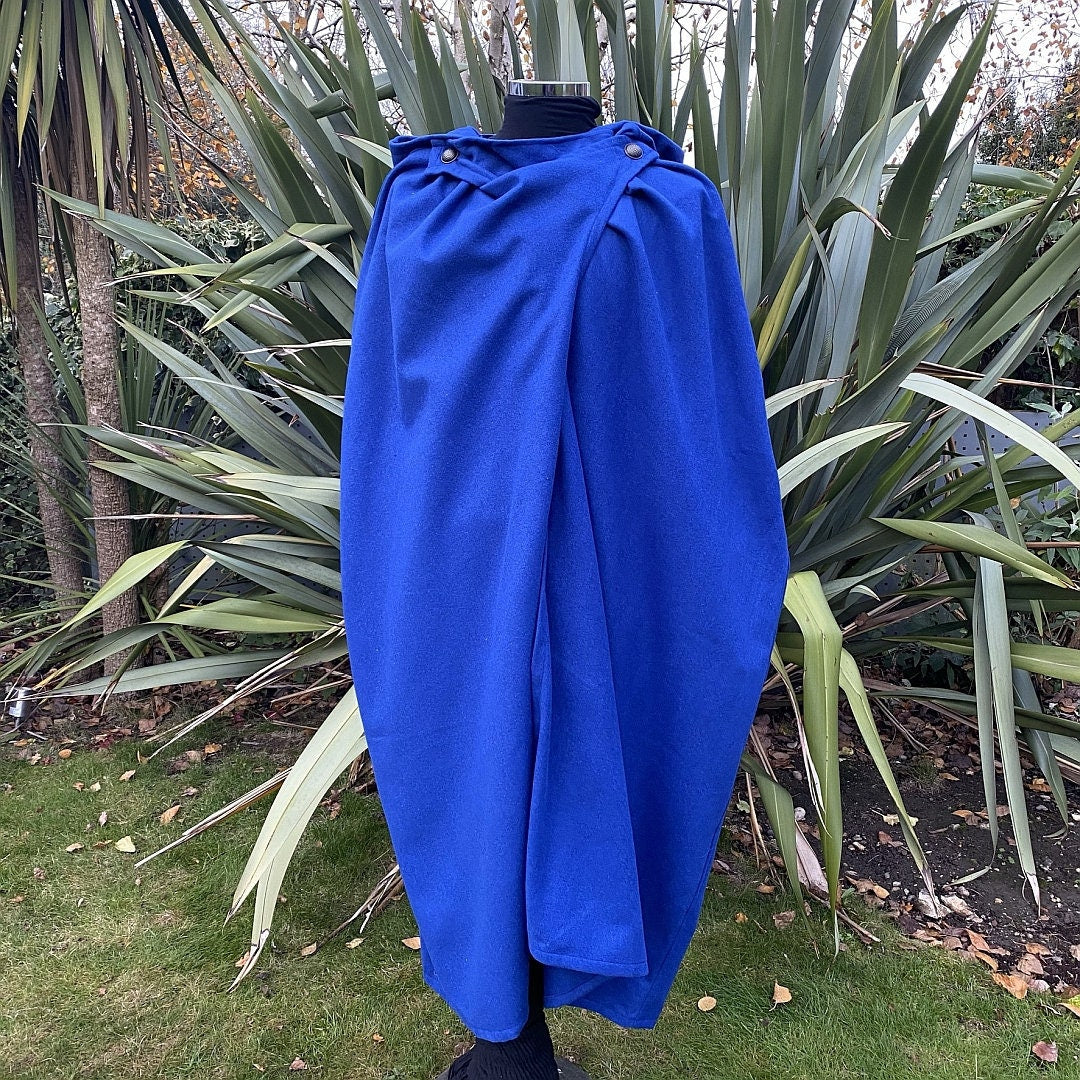 Royal blue wool cloak draped in garden setting for LARP medieval cosplay.