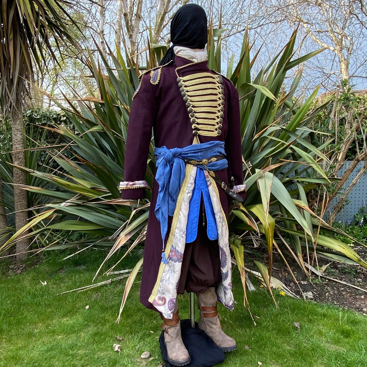Rear view of pirate LARP outfit with maroon coat and blue sash detailing.