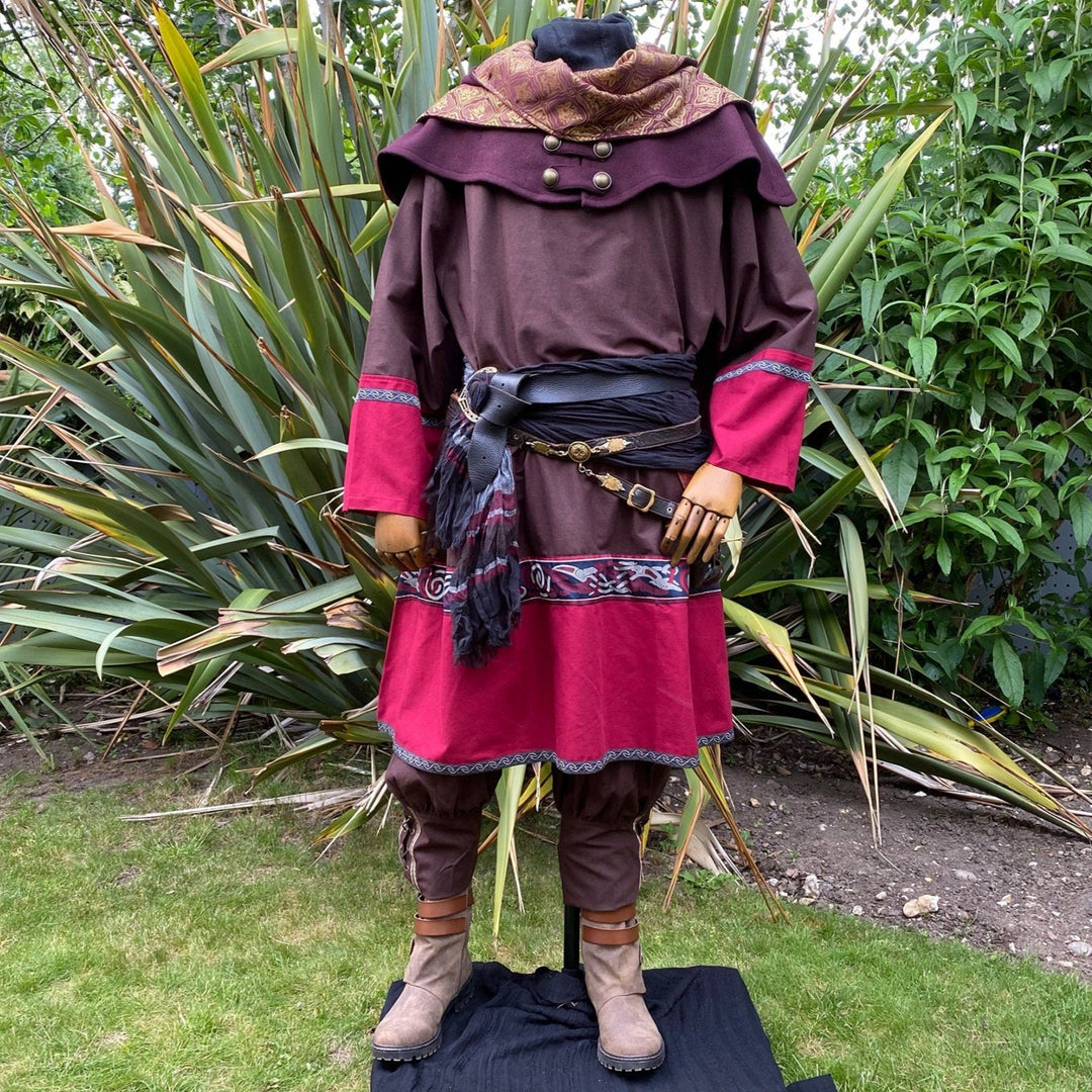 Rear garden view of LARP bard set; brown tunic, red accents, ornate hood.