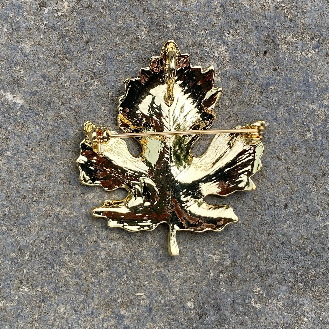 Gold leaf brooch back view on stone, medieval LARP accessory pin closure.