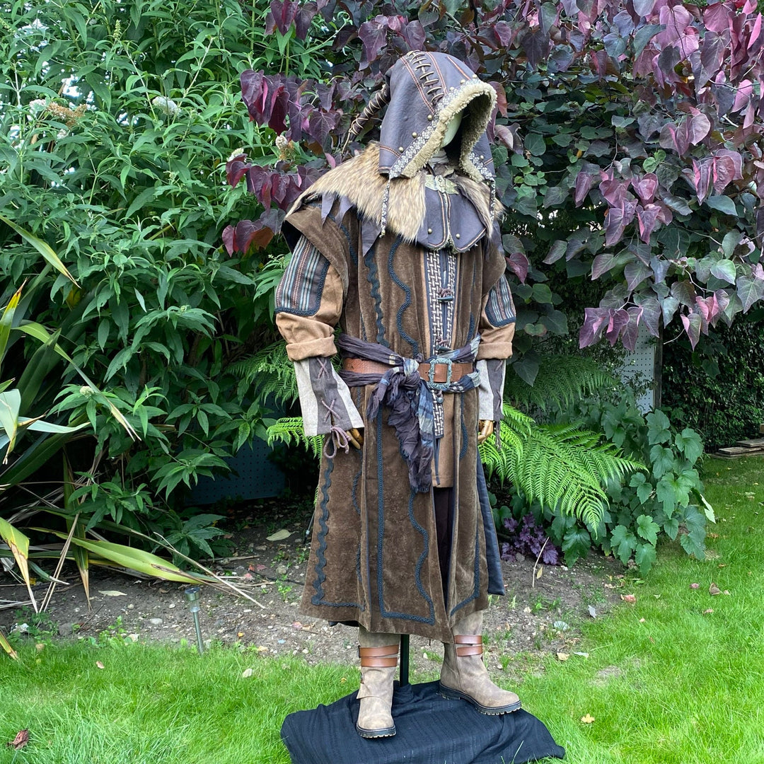 Druid LARP outfit outdoors: ornate jacket, faux leather hood, brown sash.