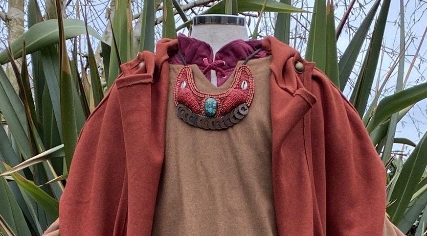 Maasai bead necklace on mannequin, earthy tones, medieval LARP costume.