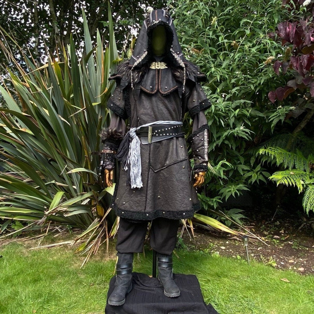 Medieval LARP costume front view featuring a black faux leather tunic, hood, vambraces, shirt.