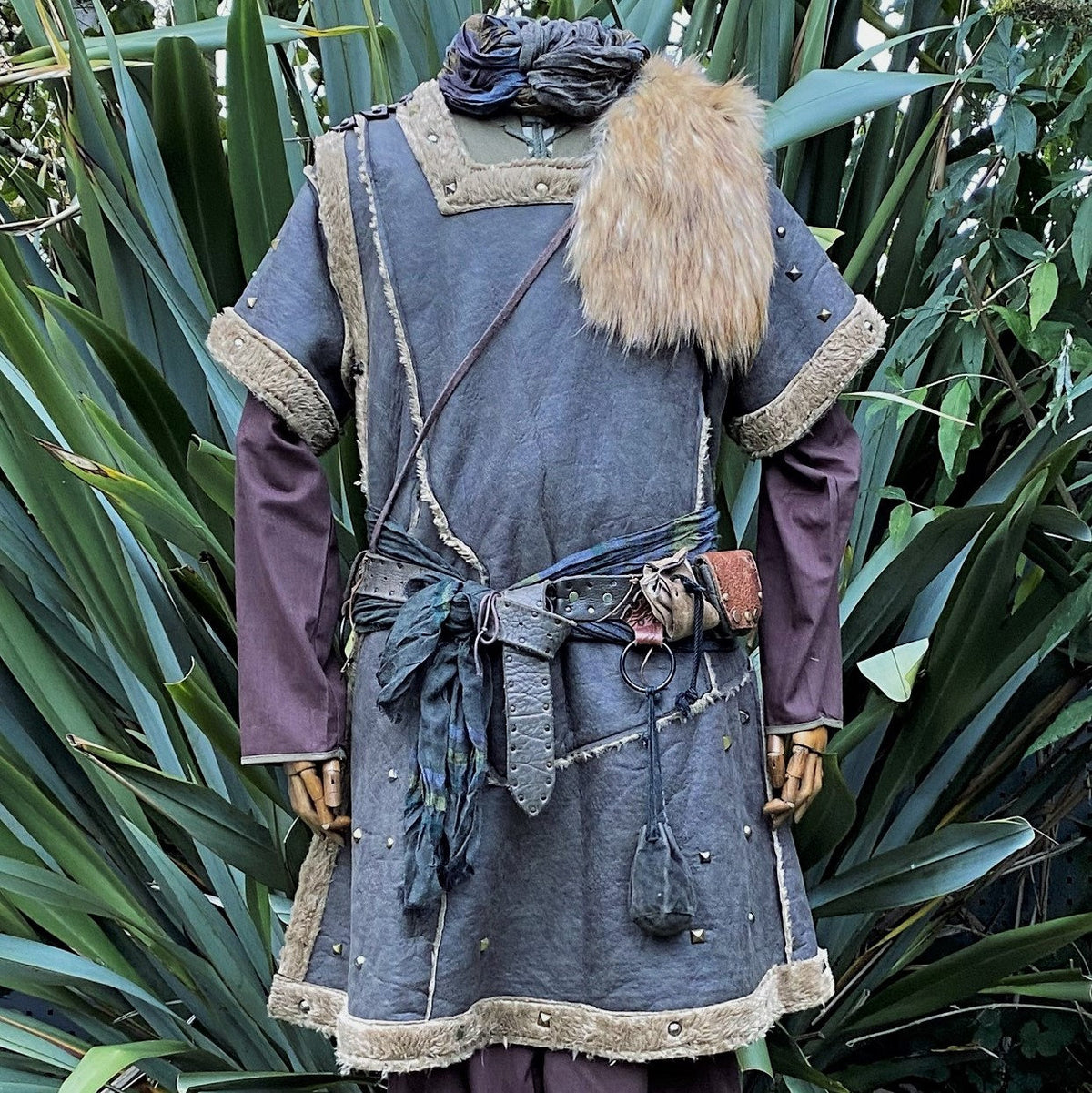 green studded tunic styled in fantasy medieval look.