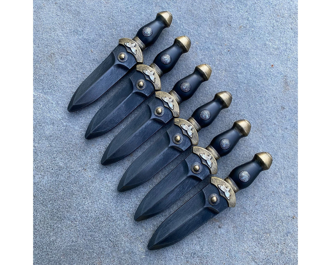 Six medieval-style foam daggers in gun metal, arranged horizontally for LARP.