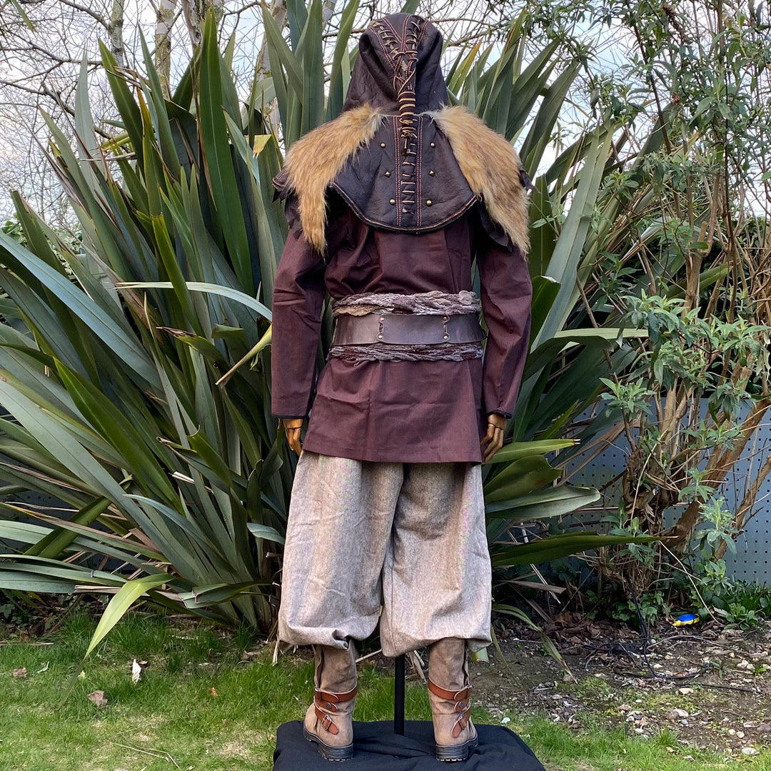Brown and beige LARP medieval outfit, fur-trimmed hood, rear view, natural setting.