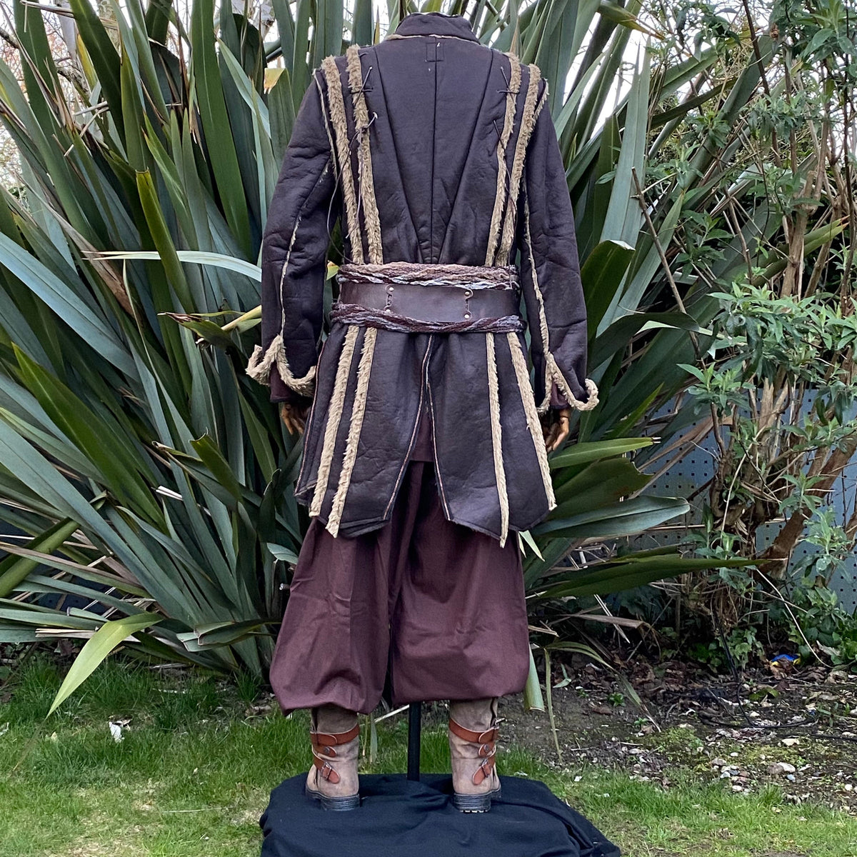 Back view of brown Viking warrior coat with flared panels and medieval detailing.