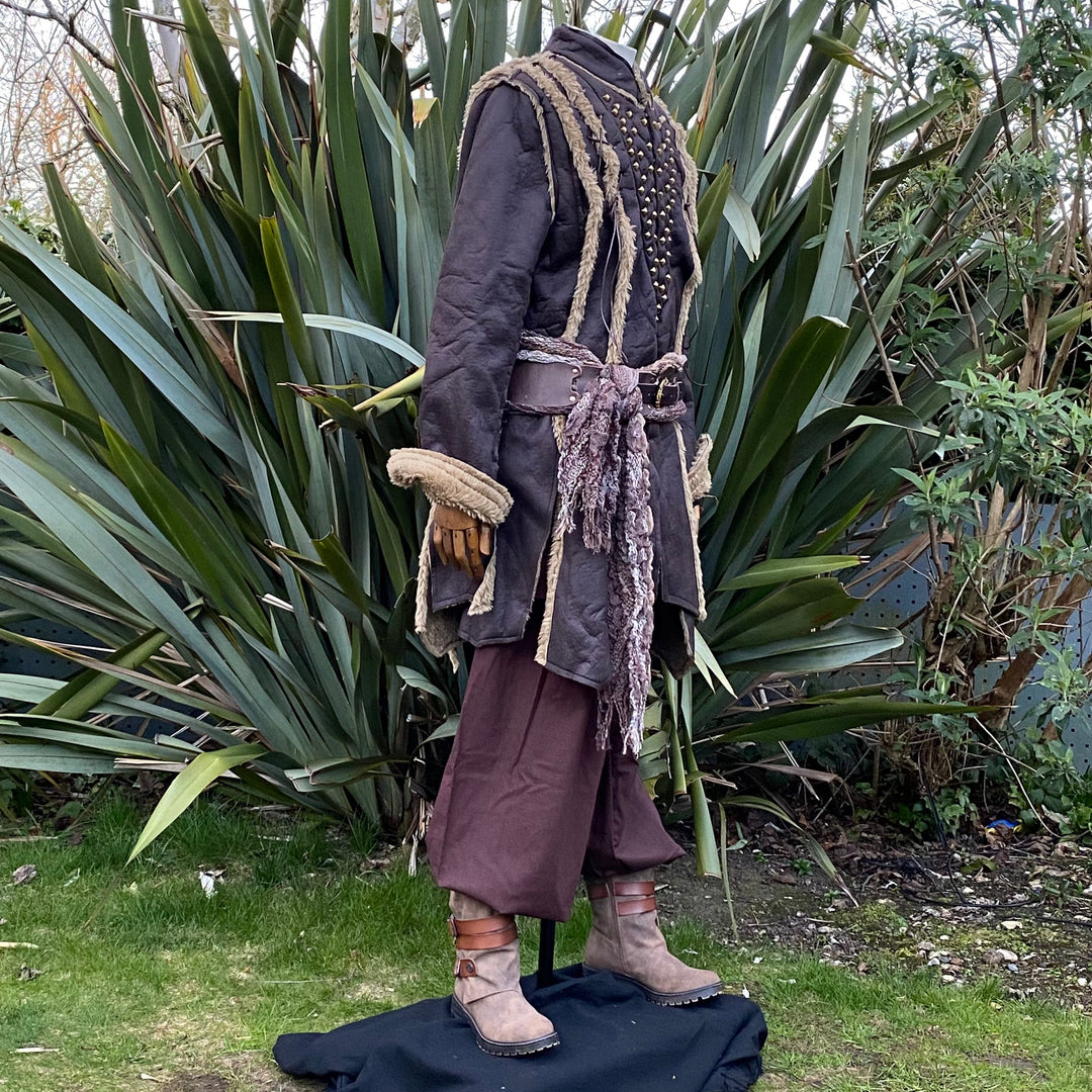 Three-quarter front angle of brown faux leather LARP coat showing V-shaped studded front.