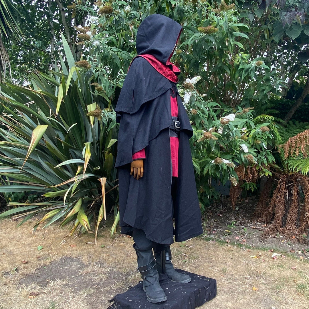 Medieval LARP costume side view featuring a 3-layered cloak, shirt and sash.