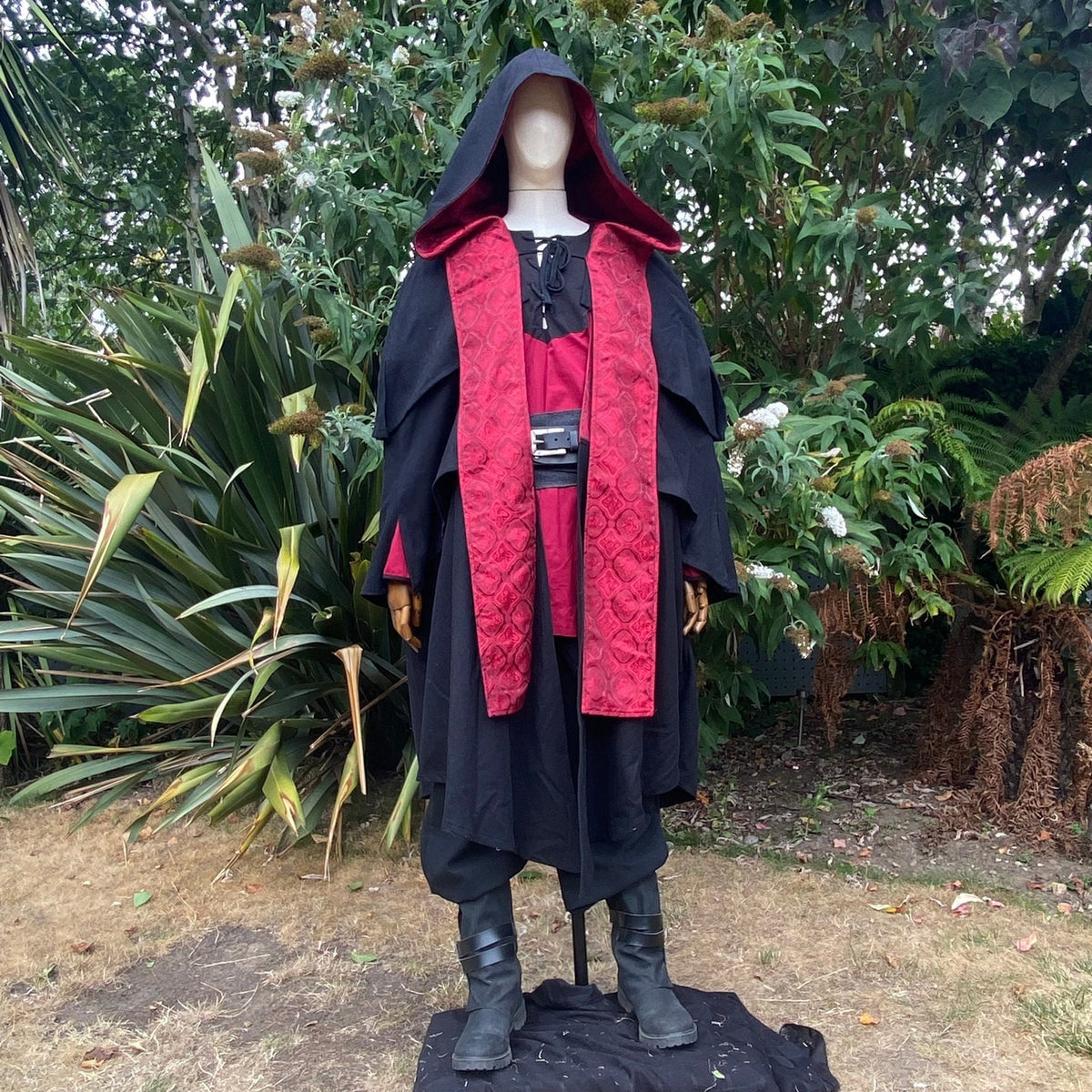 Medieval LARP costume front view featuring a 3-layered cloak, shirt and sash.