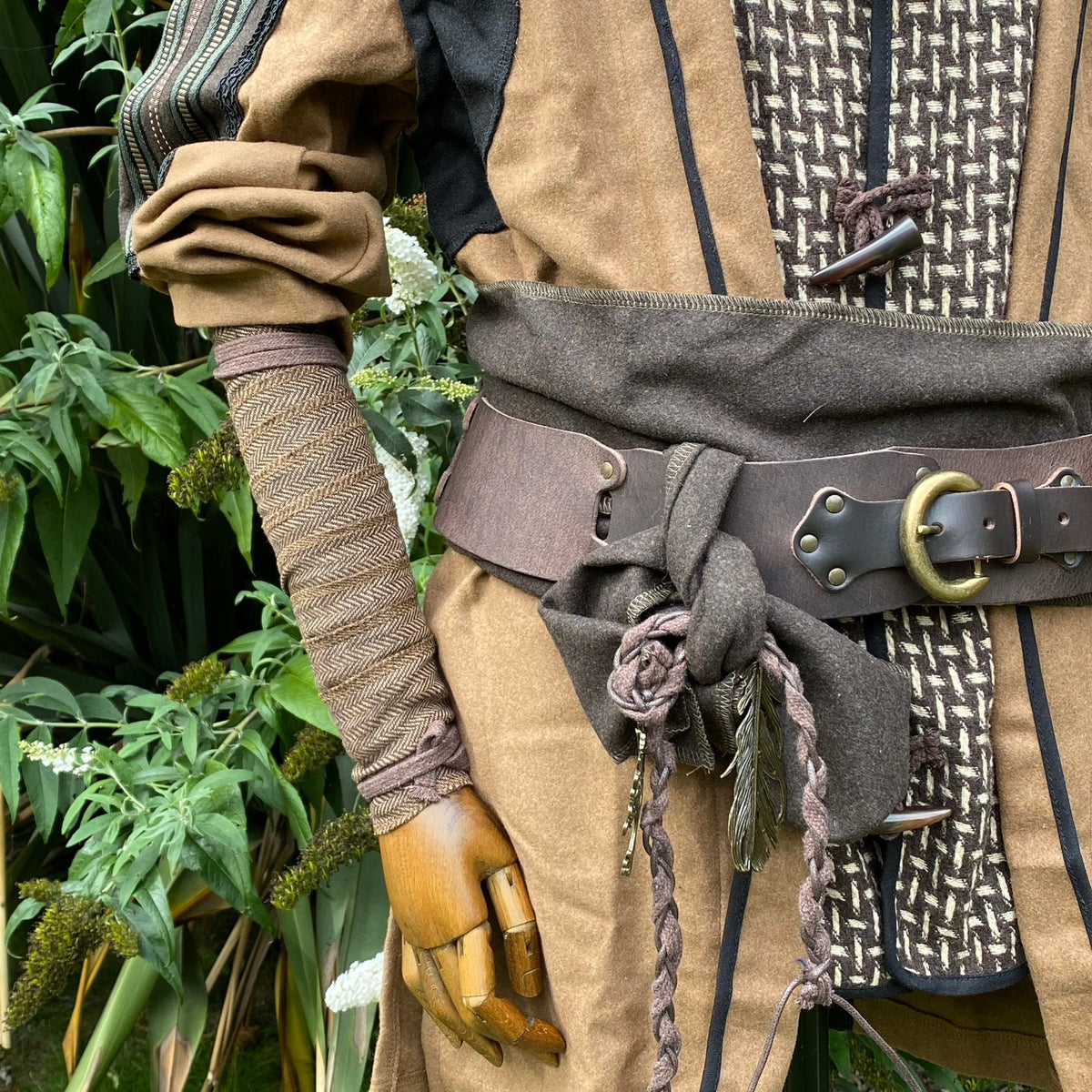 Medieval LARP costume with brown herringbone arm wrap detail.