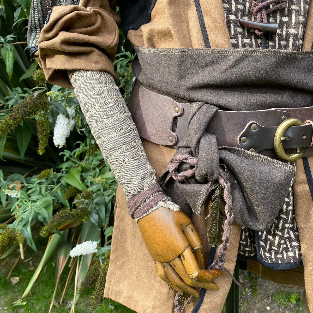 LARP outfit detail with herringbone wool arm wrap and braided belt.