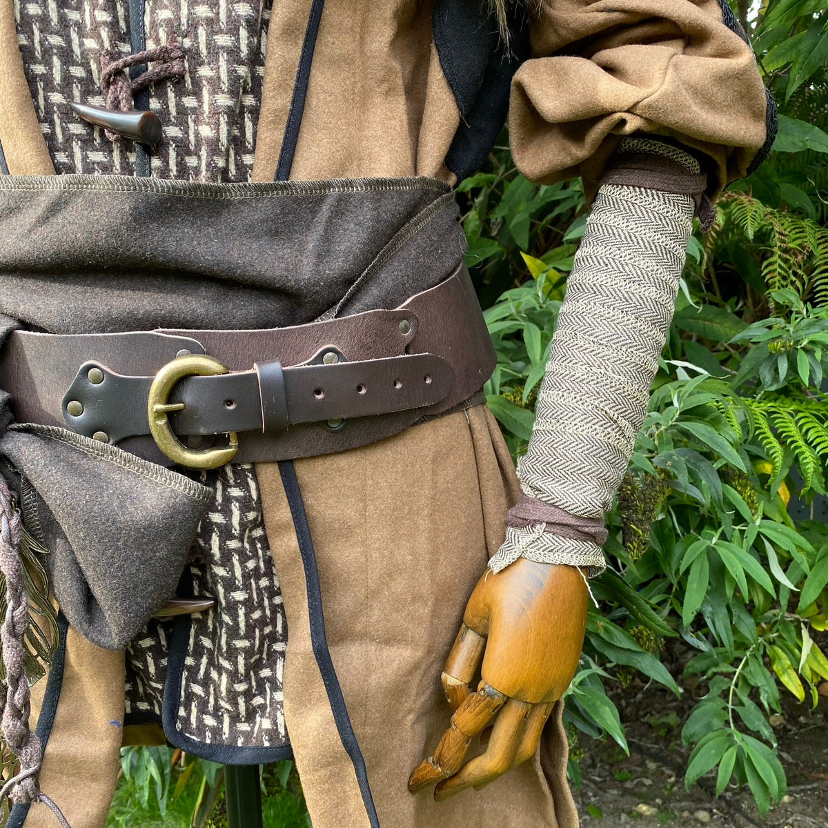 LARP wool arm wraps in herringbone, styled with medieval brown tunic and belt.