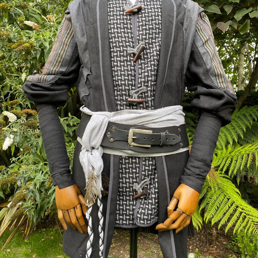 Medieval LARP arm wraps in herringbone, worn with a belt.