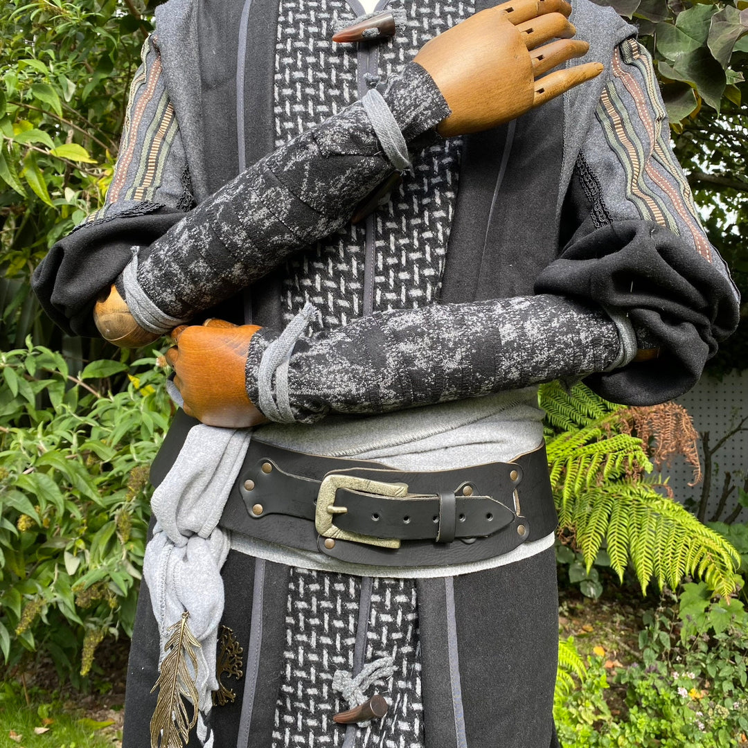 LARP medieval wool arm wraps in grey-black, crossed on a mannequin.