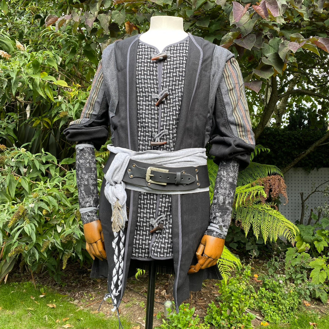 Mannequin in LARP costume, detailed grey-black arm wraps.