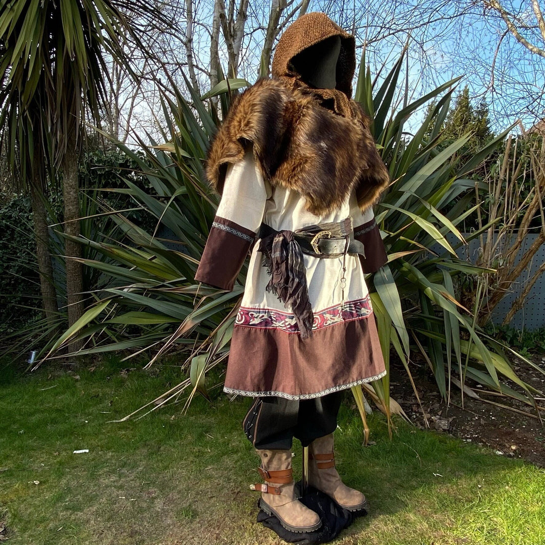 Medieval LARP outfit side view with fur mantle and embroidered tunic.