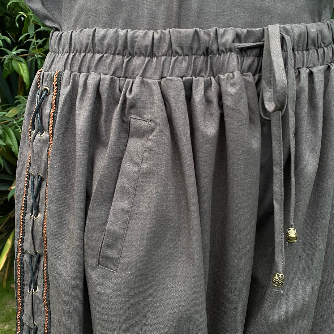 Grey medieval pants close-up with side lace, braiding, and tie detail for LARP.