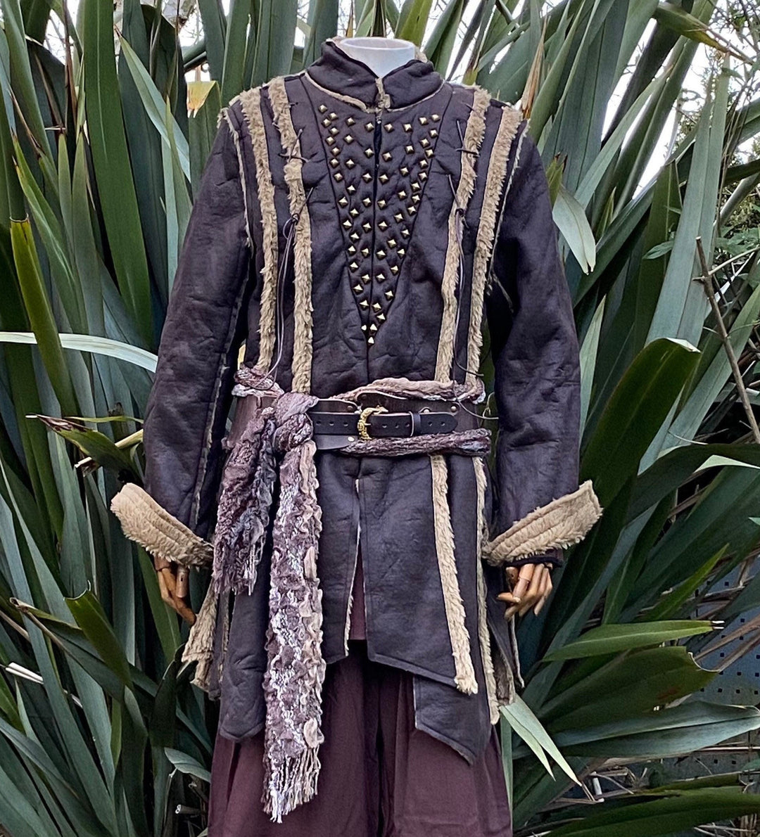 Front view of faux leather Viking coat with metal studs and textured belt.